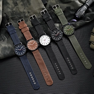 Close-up of military quartz watches with nylon straps in multiple colors and matte black cases