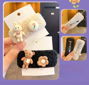 Detail of plush lamb wool hair clips with cartoon bears and metallic spring mechanism
