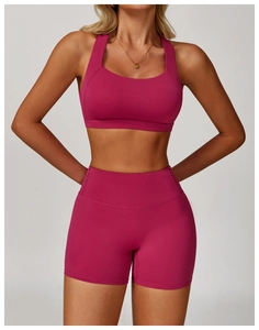 Close-up of high-waist magenta yoga set showing the seamless elastic fabric and slim fit