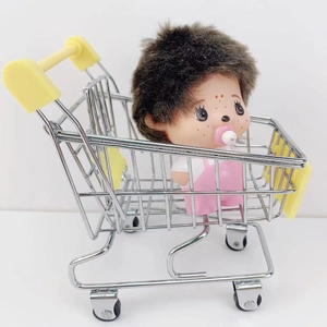 Miniature metal supermarket shopping cart toy with a cute plush doll on white background