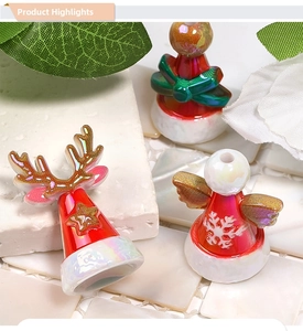 Macro shot of festive beaded Christmas charms with reindeer, angel and bow designs