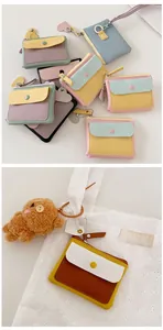 Detailed view of macaron PU leather coin purse with heart pendant and front pocket
