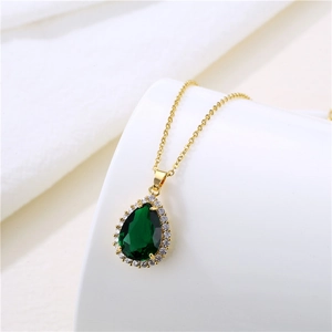 Detail view of water-drop emerald green zircon pendant on a gold stainless steel necklace