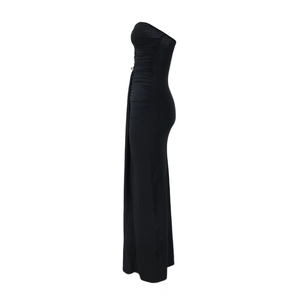Detail view of the elegant ruching and slim fit profile on a black tube maxi dress