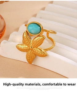 Detailed macro view of a gold starfish ring with a blue turquoise oval gemstone