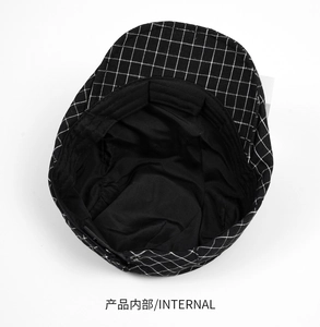 Detail of the black and white checkered flat cap showing the internal lining and stitching