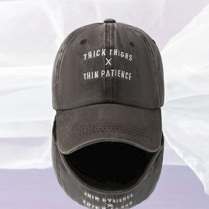 Close-up of THICK THIGHS embroidery on washed charcoal grey cotton baseball cap