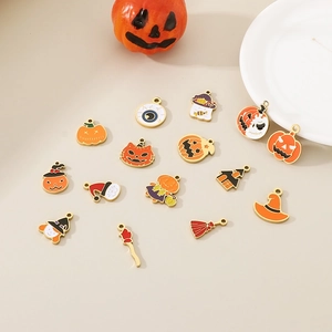 Assorted Halloween charms featuring pumpkin, ghost and witch motifs on a neutral surface
