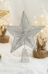 Detailed close-up of a silver glittered wire star topper with a spiral metal base
