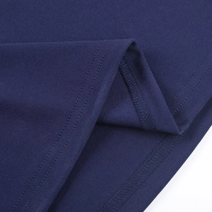 Detailed view of the double-needle hem and premium navy knit fabric texture on the dress