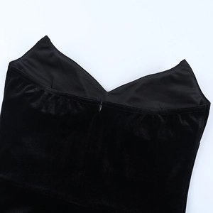 Detail of black velvet tube dress featuring a deep V-back and hidden zipper closure