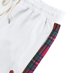 Close-up of elastic waistband with drawstring and plaid side stripes on white joggers