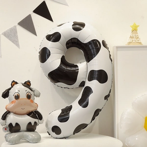 Detail of a cow print number 9 foil balloon and cow balloon for birthday party decorations