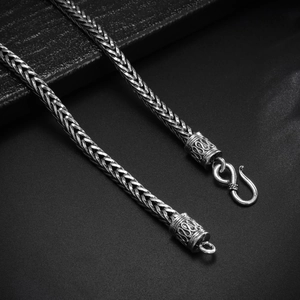 Macro detail of 4mm silver snake chain with vintage texture and S-hook clasp