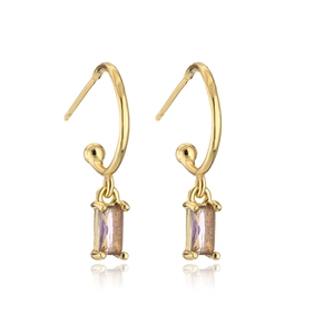 Detail of gold C-shaped earrings featuring a rectangular lavender gemstone pendant