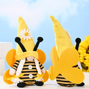 Bee gnome plush dolls with yellow hats and wings against a sunny garden background