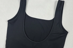 Close-up of black U-neck athletic bodysuit showing high-elastic fabric and fine stitching