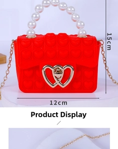 Detail view of red heart silicone bag with pearl handle and size dimensions 12cm by 15cm