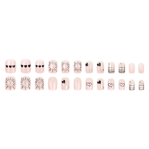 Pearlescent pink press-on nails set with black heart patterns and sunburst designs
