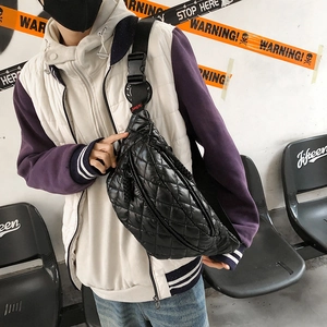 Black quilted puffer waist bag with adjustable strap and diamond stitching for winter fashion