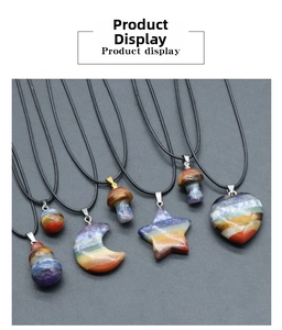 Macro detail of various chakra gemstone pendants in heart, star, and moon shapes