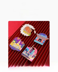 Detailed view of Shanghai landmark enamel pins featuring Oriental Pearl Tower on red paper