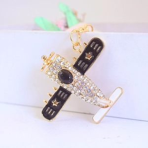 Fighter jet airplane keychain featuring clear rhinestones and black enamel wing detail