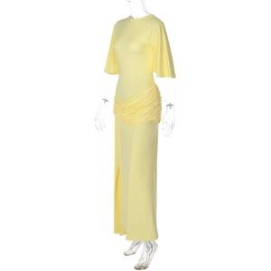 Detailed view of the yellow maxi dress with waist pleats and side slit design