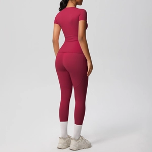 Rear view of slim fit yoga set featuring burgundy short sleeve top and high waist leggings