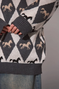 Detail of gray diamond knit sweater with jacquard horse pattern and ribbed cuffs