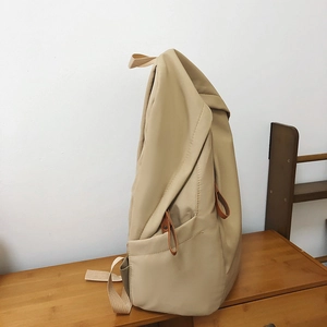 Minimalist khaki waterproof nylon backpack for school and travel with spacious side pockets