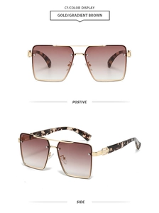 Detail view of square sunglasses with gold frames, gradient lenses and tortoiseshell tips