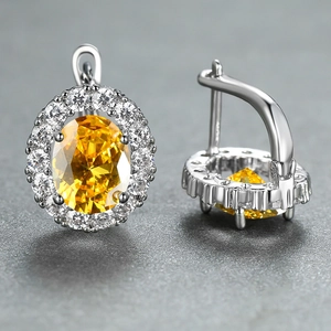 Elegant silver leverback earrings with oval yellow gemstone and white diamond halo