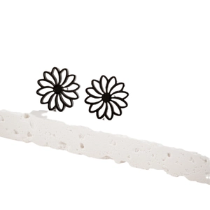Minimalist hollow lotus flower earrings in black finish on natural stone background