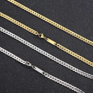 Detailed view of silver and gold stainless steel NK chains on black background