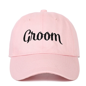 Close-up of pink baseball cap with black Groom embroidery and premium cotton texture