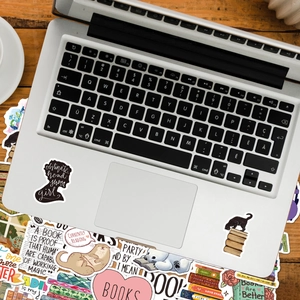 Close-up of waterproof reading stickers with book and animal motifs on a laptop