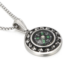 Silver steel compass necklace with skull engraving and functional black dial on white background