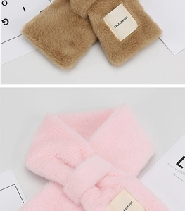 Detail of soft faux rabbit fur scarf in brown and pink with stylish woven label tag