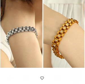 Detail of luxury 18k gold and silver plated watch-style bracelets with white cubic zirconia