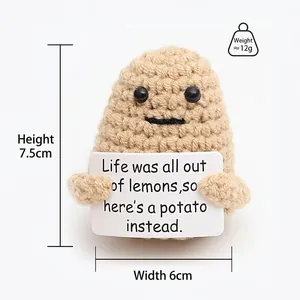 Close-up of handmade crochet potato doll with encouraging card showing knit textures