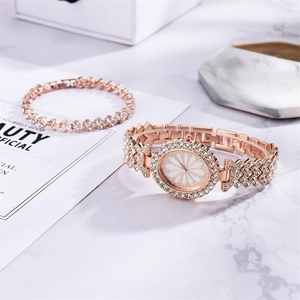 Close-up of luxury rose gold daisy watch and crystal bracelet on marble surface
