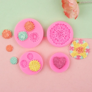 Flat lay of flower and heart shaped silicone molds for fondant and chocolate baking