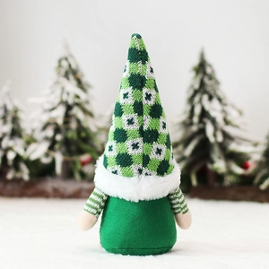 Christmas gnome plush toy with green plaid hat and reindeer antlers on snowy background