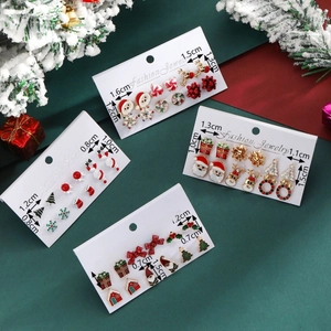 Christmas stud earring sets with enamel reindeer, tree, and snowflake designs on card