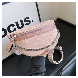 Detail of pink pleated crescent bag with pearl chain and geometric pattern strap