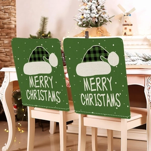 Detail of green linen Christmas chair covers with plaid hats and Merry Christmas text