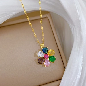 Elegant gold titanium necklace featuring a rotating flower pendant with multi-colored crystals