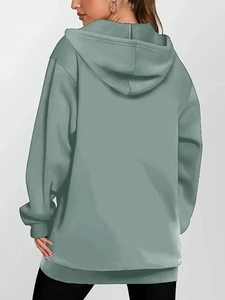 Rear view of an oversized grass green zip-up hoodie with dropped shoulder design