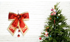 Detailed view of red and gold Christmas bow with pine cones and festive greetings